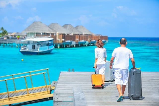 A couple on a resort's boardwalk